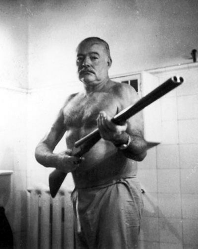 Ernest Hemingway, Hemingway with shotgun, for whom the bell tolls, a farewell to arms, legend, writer, nobel laureate - HeadStuff.org