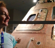 Niamh Shaw beside Apollo 15 Command Module that landed on the Moon in 1971 (Credit Remco Timmersmans) - HeadStuff.org