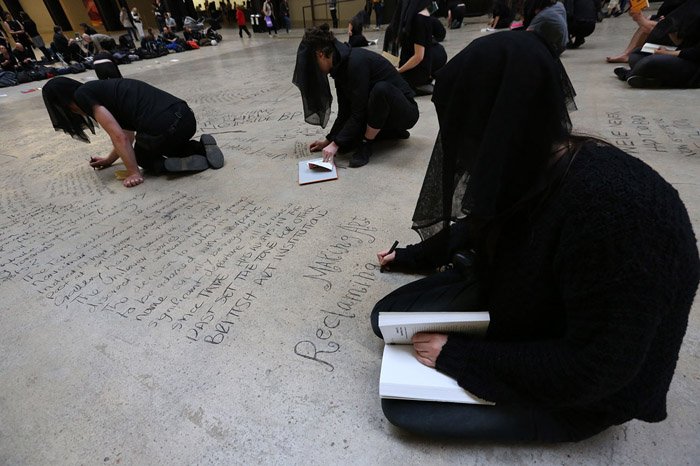 Performers writing on the floor of the museum-Headstuff.org