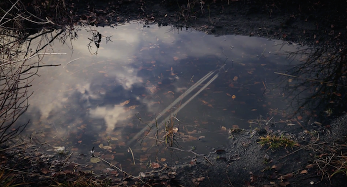 water puddle with reflection of airjet