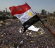 Man waves flag over Tahrir Square in 2011