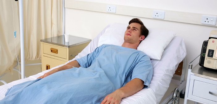 stock-footage-sick-man-lying-on-hospital-bed-in-the-hospital-ward